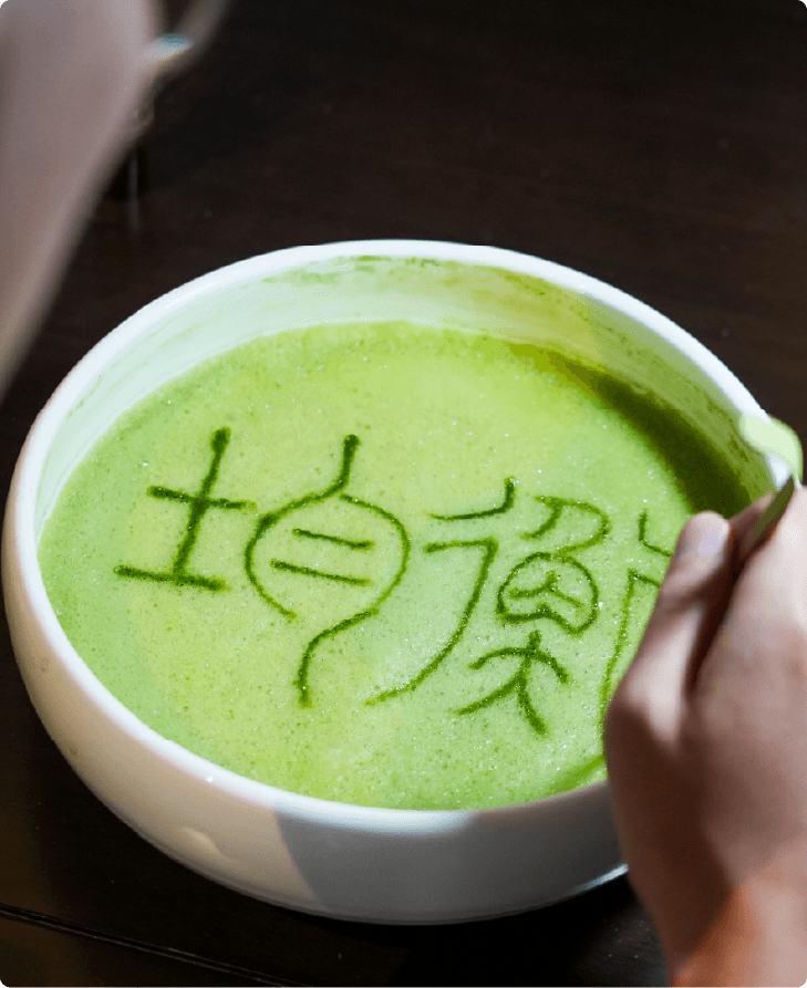 Tea art lettering in matcha foam