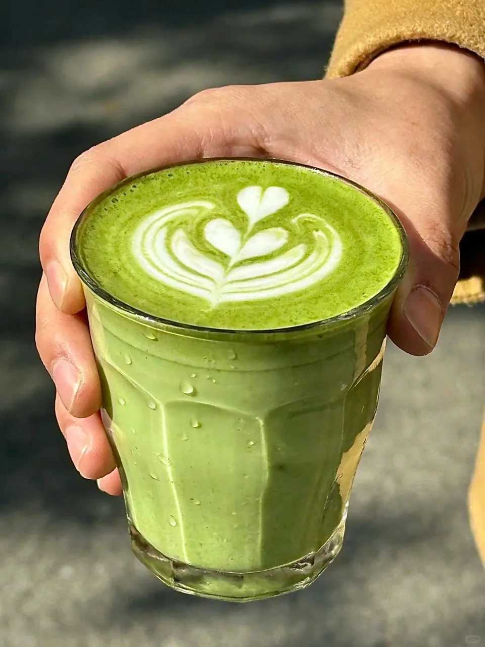 Matcha latte being poured into a glass